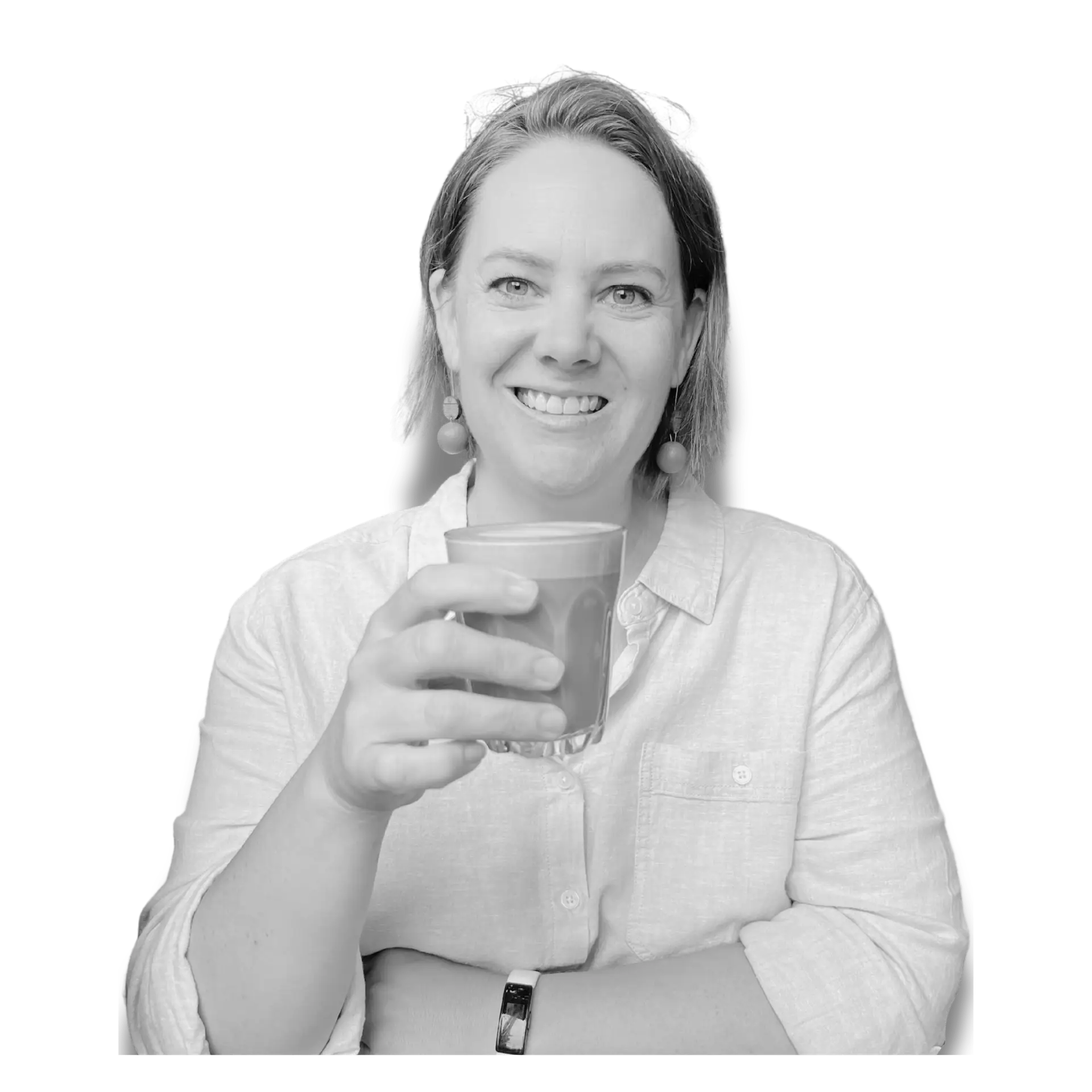 Shannon Blackburn smiling while holding a coffee during a graphic design branding photoshoot for her Australian creative business